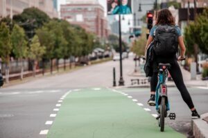 A woman biking in Boston. Learn more with our urban cyclist guide.