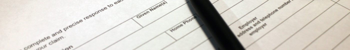 Work Injury Claim Form Someone filling out Work Injury Claim Form