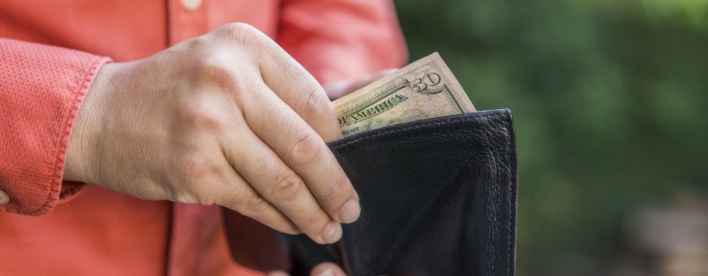 Close up of man hands with wallet and money