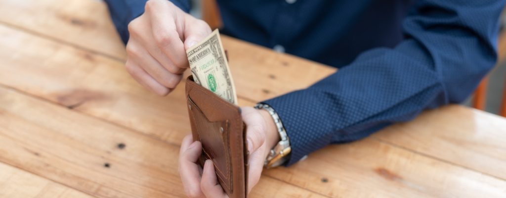 Human hand takes money bills from wallet close-up Human hand takes money bills from wallet close-up