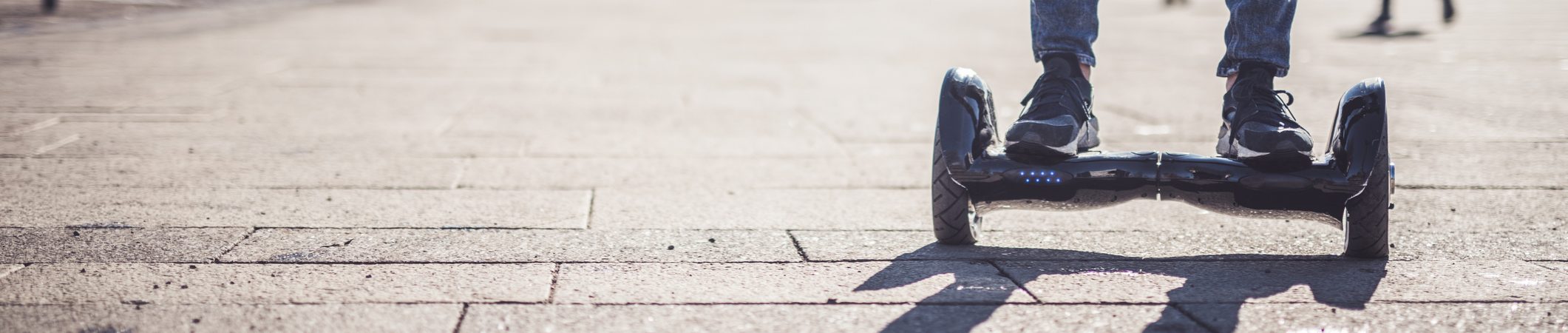 Front view of a man on a hover-board. Hoverboard Injury Lawyer