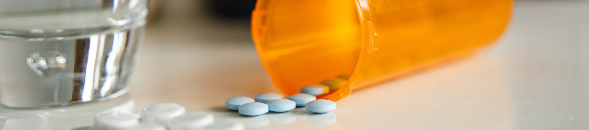 Medications and glass of water Medications and glass of water